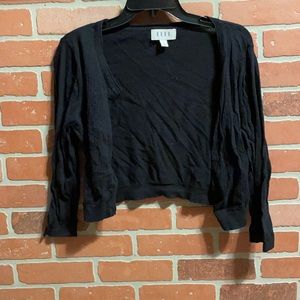Black waist length sweater with cutouts on front